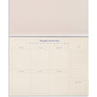 Blue Joy Undated Weekly Desk Planner by Papier with open pages showing daily and weekly scheduling sections.