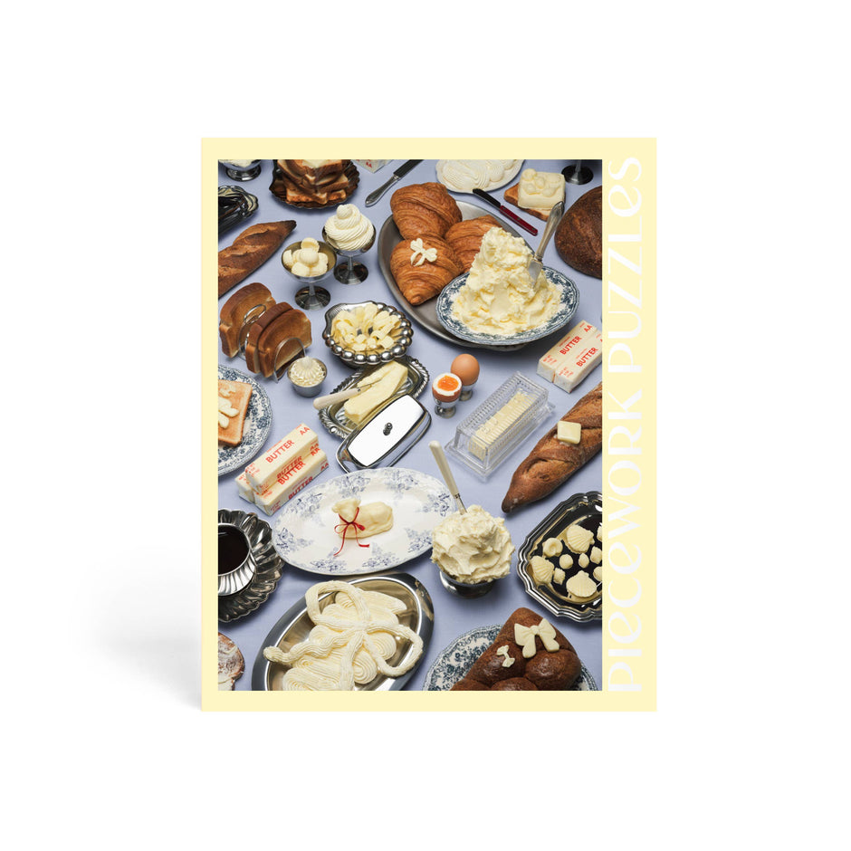Piecework 1000-piece puzzle featuring a charming illustration of butter, perfect for puzzle enthusiasts and collectors.