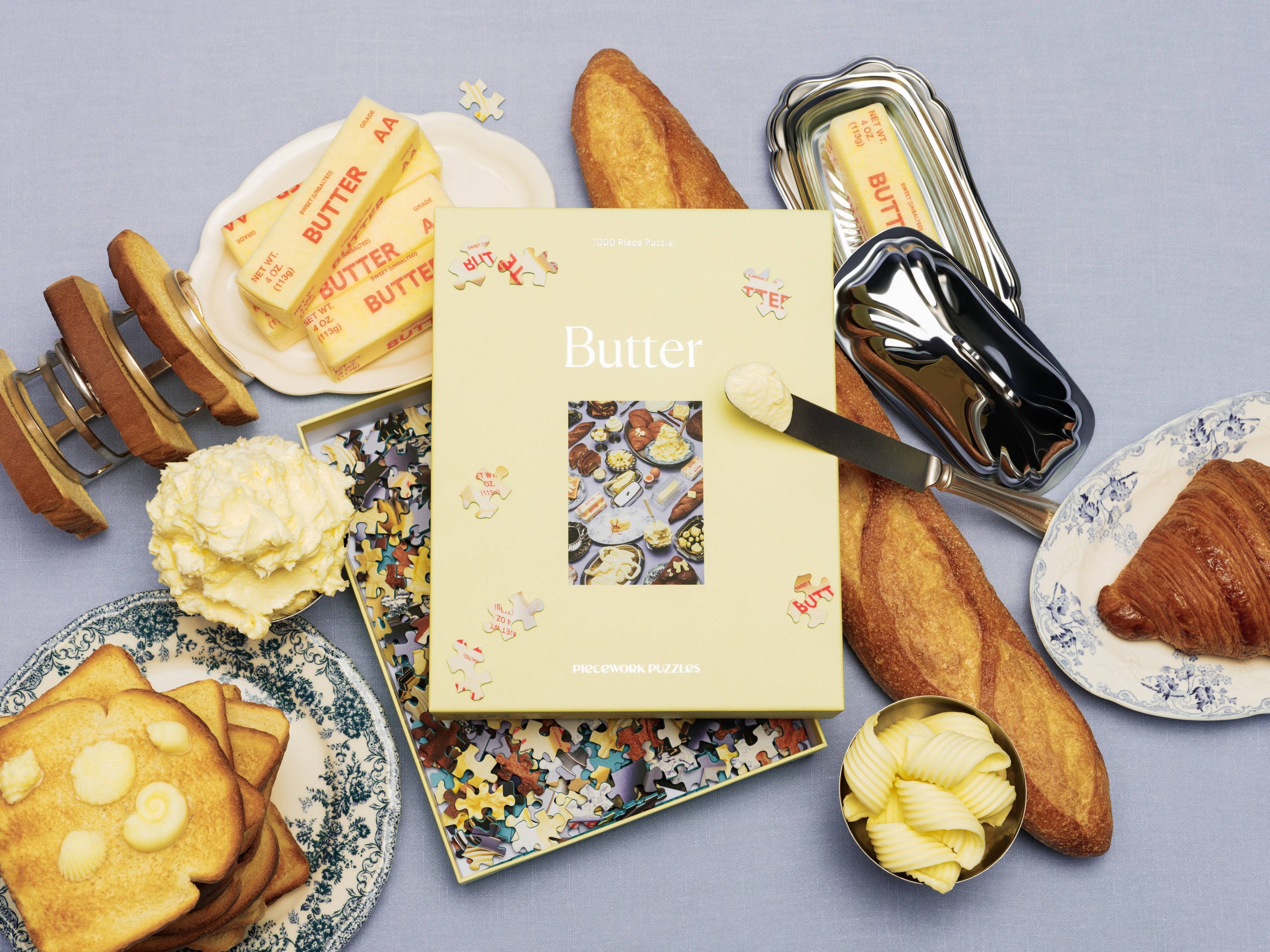Piecework New Butter 1000-piece puzzle featuring a detailed image of a butter block with vibrant colors and realistic textures.