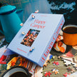 Puzzle image showing a colorful camping scene with trees, tents, and happy campers, from Piecework's 1000-piece Happy Camper puzzle.