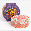 Specialty Puzzle Sugarplum Cookie Tin by Piecework featuring a festive tin with colorful holiday design and sugarplum cookies inside.