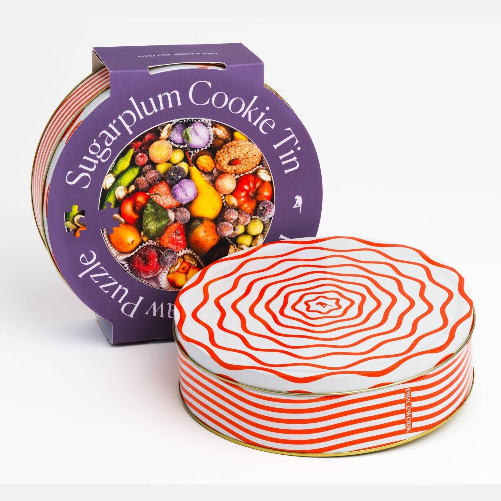 Specialty Puzzle Sugarplum Cookie Tin by Piecework featuring a festive tin with colorful holiday design and sugarplum cookies inside.