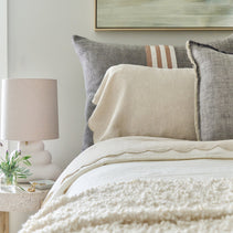 Large Pom Pom at Home Benny Big Pillow with soft fabric and decorative pom pom accents on a cozy bed or sofa.