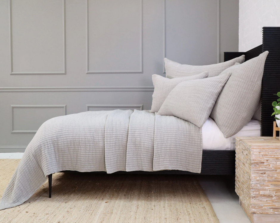 Amber Pom Pom at Home Vancouver Coverlet blanket with a soft, cozy woven texture and decorative pom pom accents.