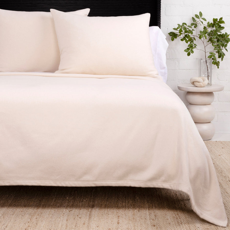 Ivory Pom Pom at Home Billie blanket with pom-pom accents, cozy and soft throw blanket for living room or bedroom decor.