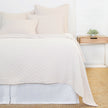 White Pom Pom at Home Ojai Matelasse Coverlet on bed, showcasing soft fabric and textured quilting for a cozy bedroom decor.