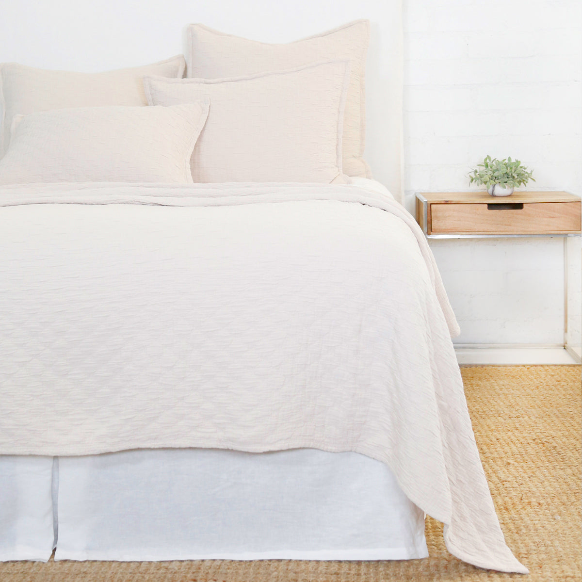 White Pom Pom at Home Ojai Matelasse Coverlet on bed, showcasing soft fabric and textured quilting for a cozy bedroom decor.
