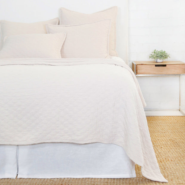 White Pom Pom at Home Ojai Matelasse Coverlet on bed, showcasing soft fabric and textured quilting for a cozy bedroom decor.