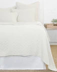 White Pom Pom at Home Ojai Matelasse Coverlet blanket with textured quilting and pom-pom accents for a cozy bedroom decor.