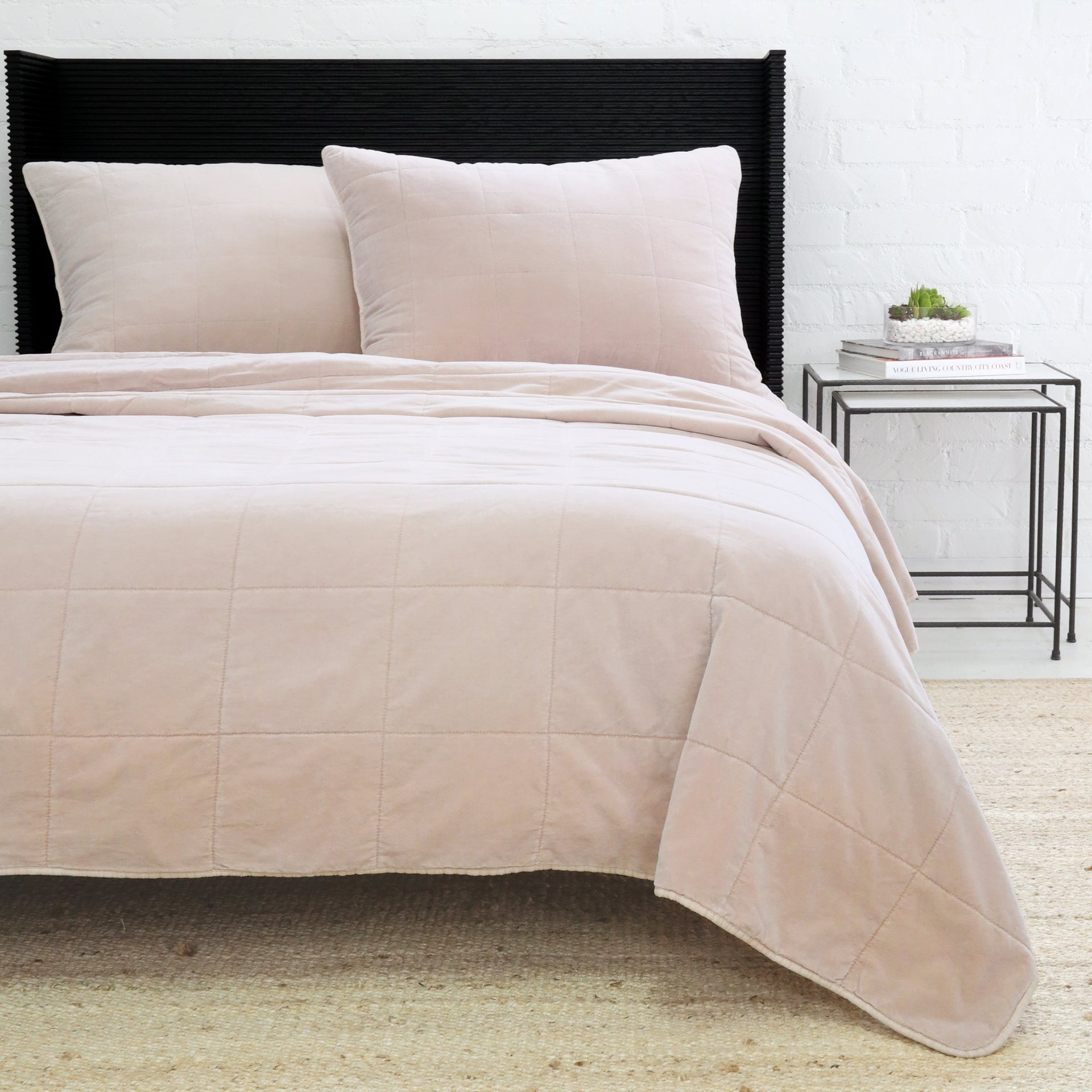 Blush Pom Pom at Home Amsterdam coverlet on a bed, showing soft fabric and decorative pom pom trim for a cozy bedroom look.