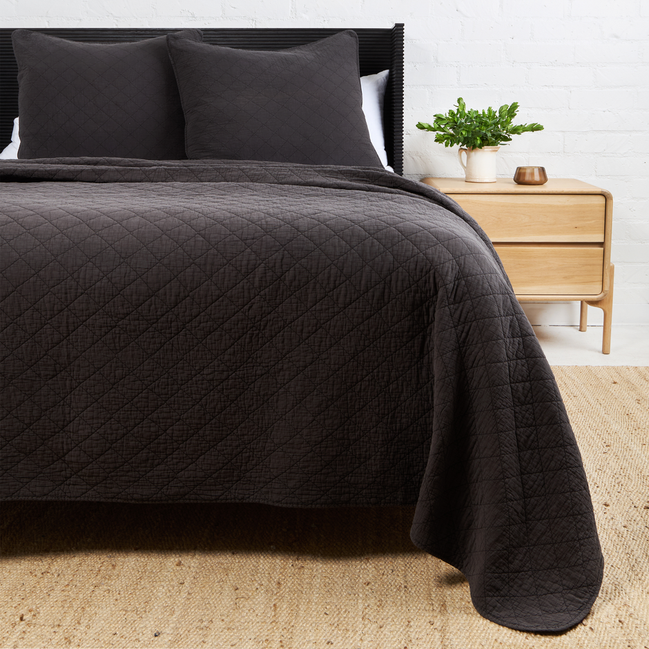 Pom Pom at Home Huntington coverlet in midnight with a soft, woven fabric and decorative tassels for a cozy bedroom accent.