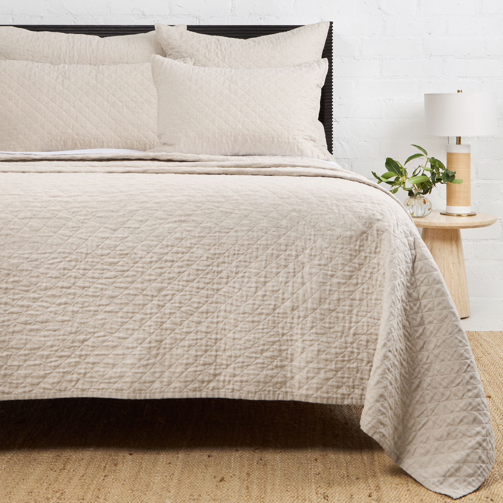 Navy Pom Pom at Home Hampton coverlet on a bed, showcasing soft fabric and decorative pom pom edges for a cozy bedroom look.