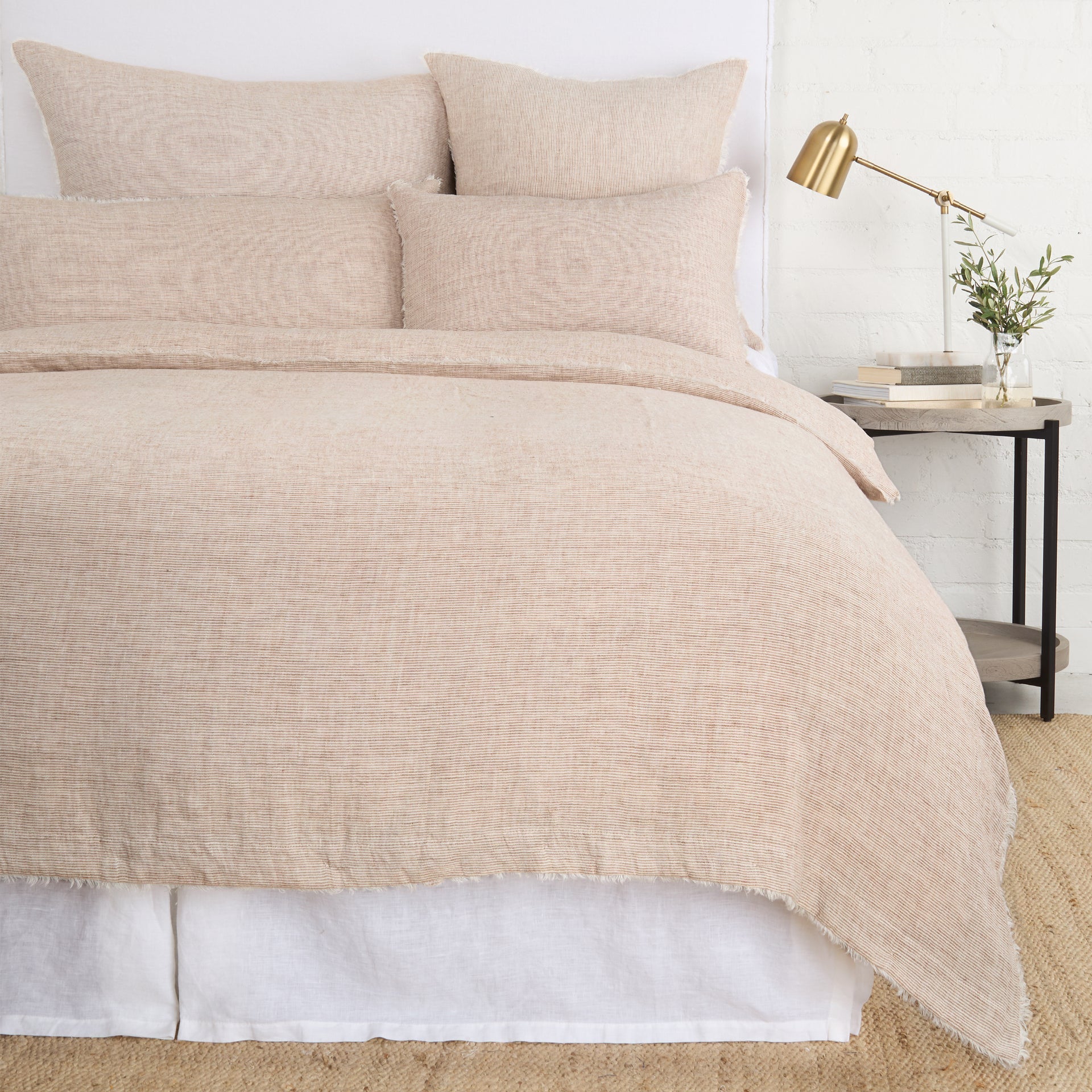 Navy Pom Pom at Home Logan duvet cover on a bed, featuring a soft fabric with a stylish, textured design.