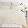 Navy Pom Pom at Home Logan duvet cover on a bed, showcasing soft fabric and decorative pom pom trim for a cozy bedroom look.