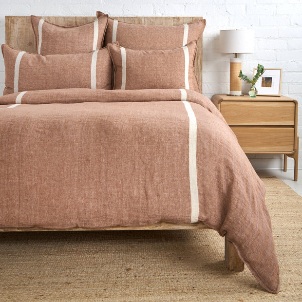 Pom Pom at Home Rory King Sham with terracotta fabric and pom-pom accents, showing a cozy, decorative bedding detail.