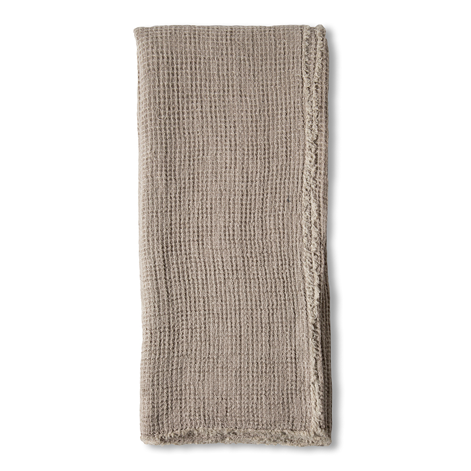 Taupe linen throw blanket by Pom Pom at Home with decorative pom-pom accents, perfect for cozy home decor.