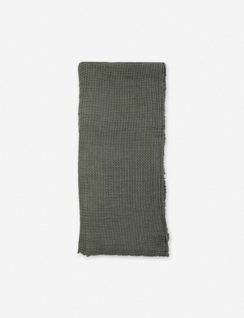 Taupe linen throw blanket from Pom Pom at Home with decorative pom-pom accents, cozy and stylish for living room or bedroom.