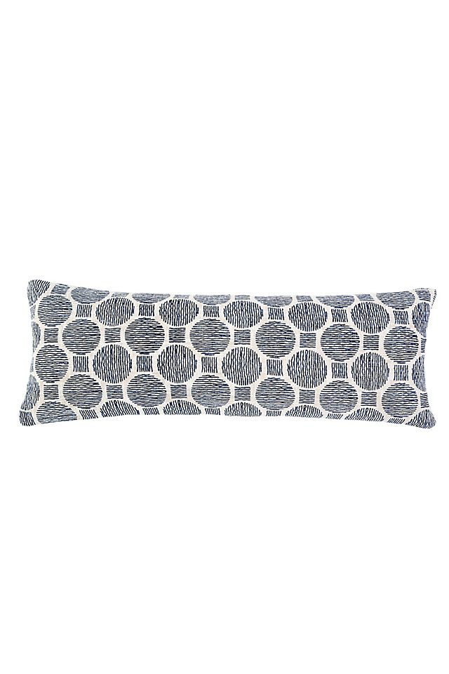 Ivory and navy Pom Pom at Home throw pillow, 14x40 inches, with decorative pom pom accents on soft fabric.