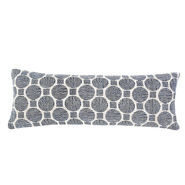 Ivory and navy Pom Pom at Home throw pillow, 14x40 inches, with decorative pom pom accents on soft fabric.