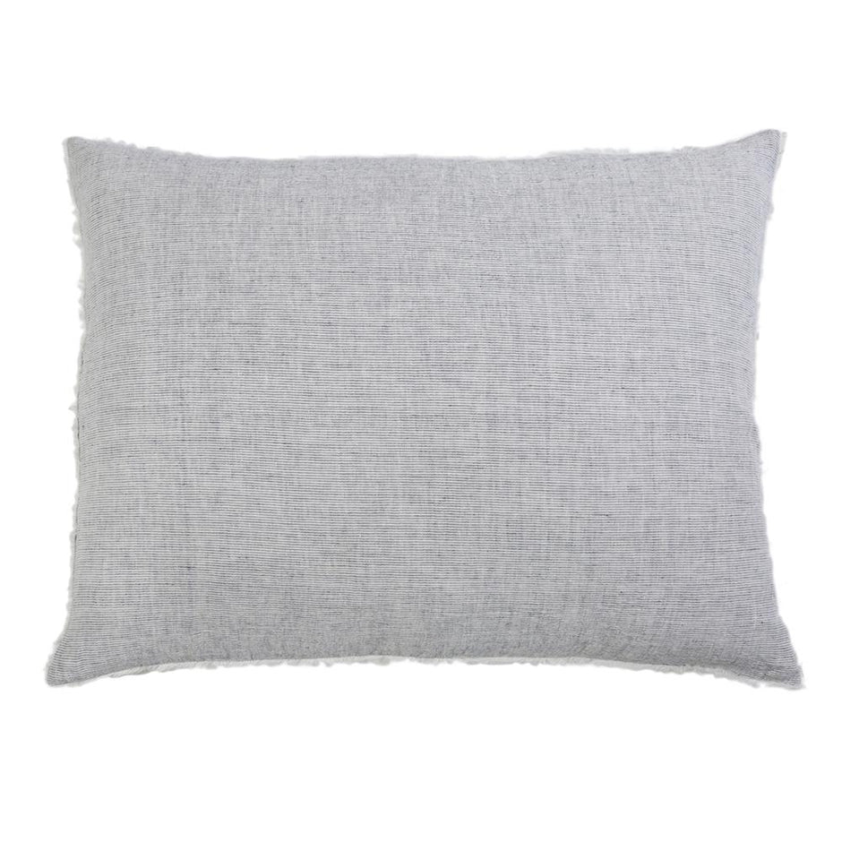 Navy throw pillow from Pom Pom at Home Logan collection with plush fabric and decorative pom pom accents.