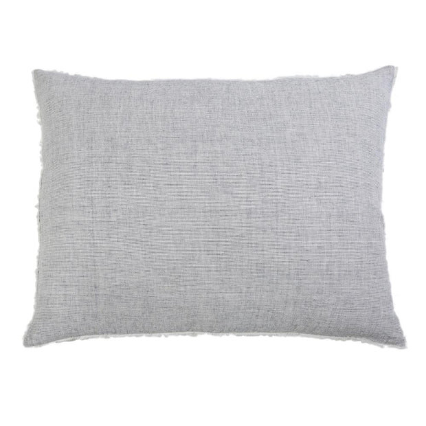 Navy throw pillow from Pom Pom at Home Logan collection with plush fabric and decorative pom pom accents.