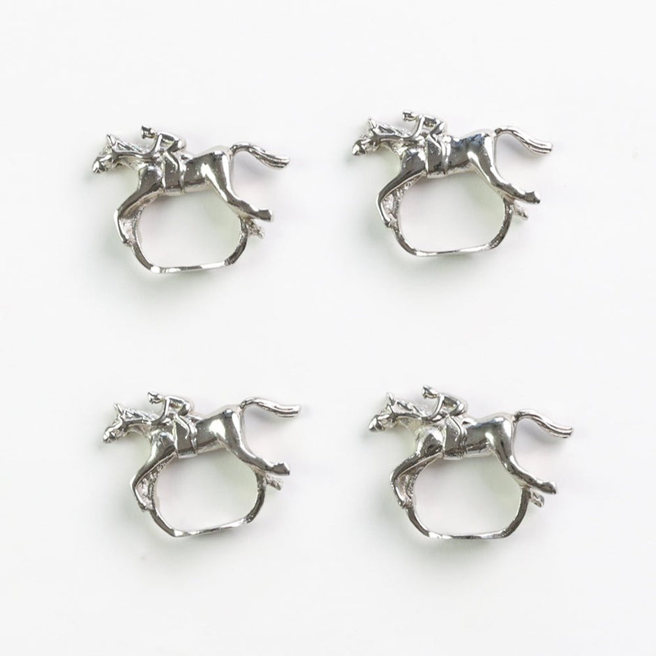 Set of four silver horse jockey napkin rings by Pomegranate, featuring detailed equestrian design for elegant table settings.