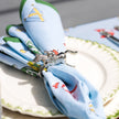 Set of four silver horse jockey napkin rings with vintage style, featuring detailed jockey figures on a decorative table setting.