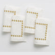 Set of four India Hicks gold stars cocktail napkins by Pomegranate, elegant table linens with star pattern for entertaining.