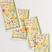 Pomegranate 70's Flower napkin, part of table linens collection, featuring vibrant floral pattern on soft fabric.