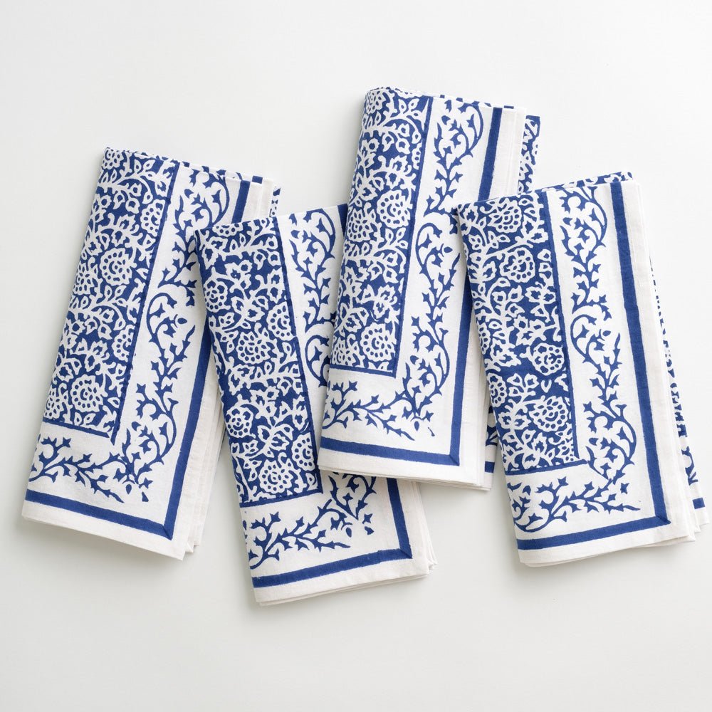 Dark blue napkin tapestry from Pomegranate, part of the table linens collection, featuring intricate woven design.
