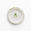 Set of four Pomegranate ruffled appetizer plates with elegant linen table linens for serving small dishes.