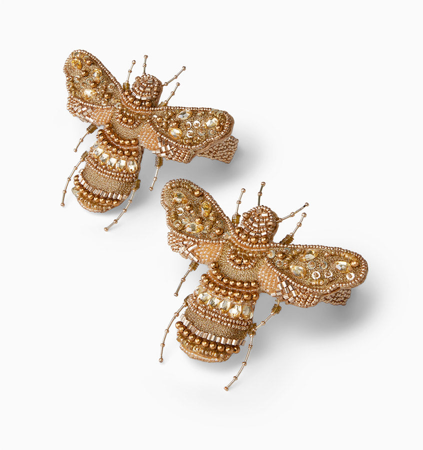 Set of two Sferra Vita Bee cocktail napkin rings with elegant gold bee design, perfect for sophisticated table settings.