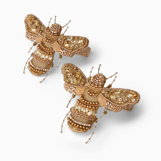 Set of two Sferra Vita Bee cocktail napkin rings with elegant gold bee design, perfect for sophisticated table settings.