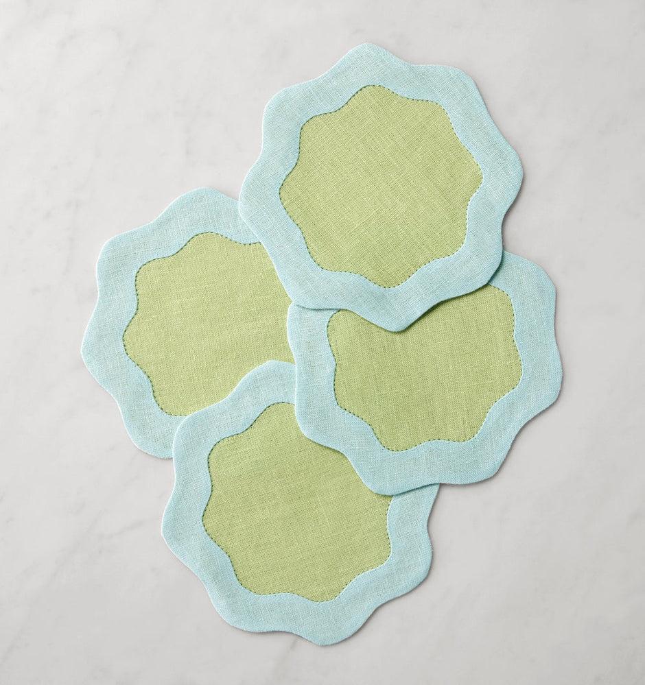 Set of six Sferra Ondulato cocktail napkins in forest celadon with elegant wavy pattern, perfect for stylish gatherings.