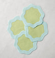 Set of six Sferra Ondulato cocktail napkins in forest celadon with elegant wavy pattern, perfect for stylish gatherings.