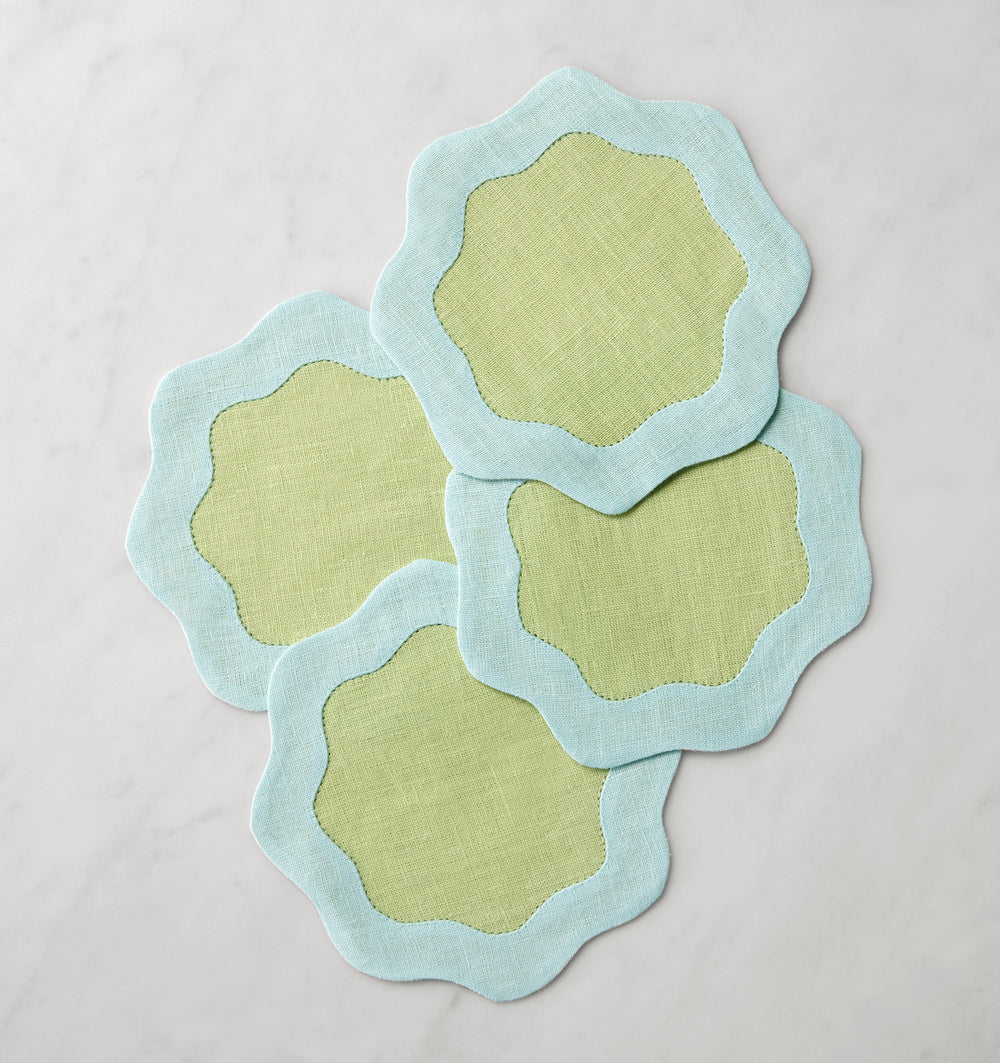 Set of six Sferra Ondulato cocktail napkins in forest celadon with elegant wavy pattern, perfect for stylish gatherings.