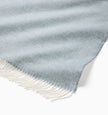 Beige Sferra Cervino throw blanket with soft, woven fabric draped over a sofa for cozy comfort and elegant decor.