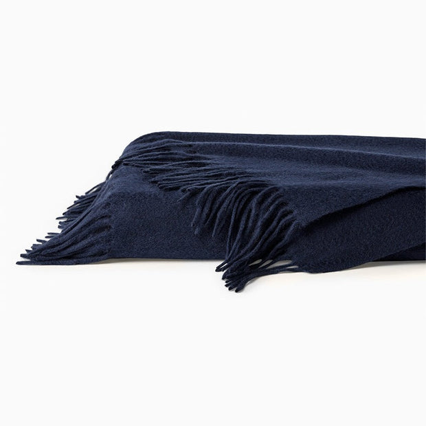 Midnight blue Sferra Dorsey Throw blanket with soft, plush fabric, showcasing elegant texture and cozy design.