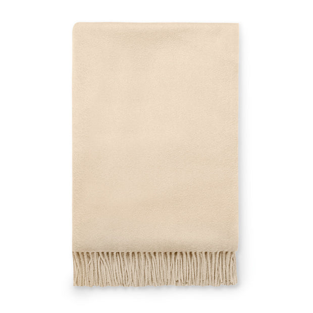 Midnight blue Sferra Dorsey throw blanket with soft, plush fabric and decorative fringe detailing.