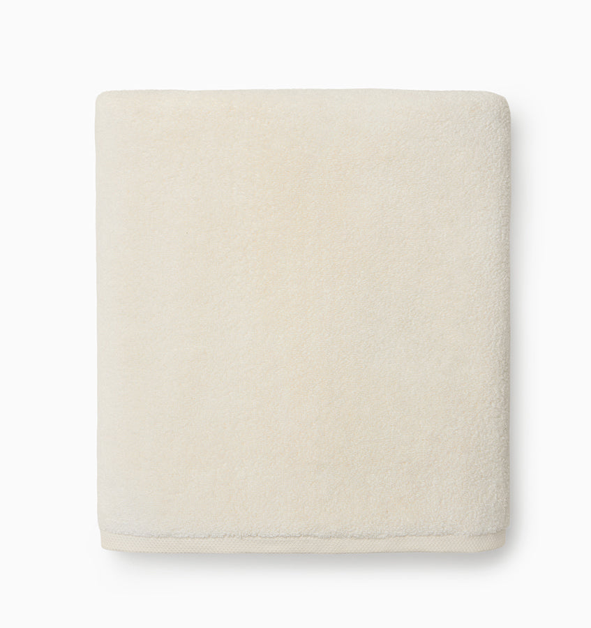 Ivory Sferra Cielo bath washcloth showing soft, plush fabric with subtle texture, perfect for gentle skincare and bath time.