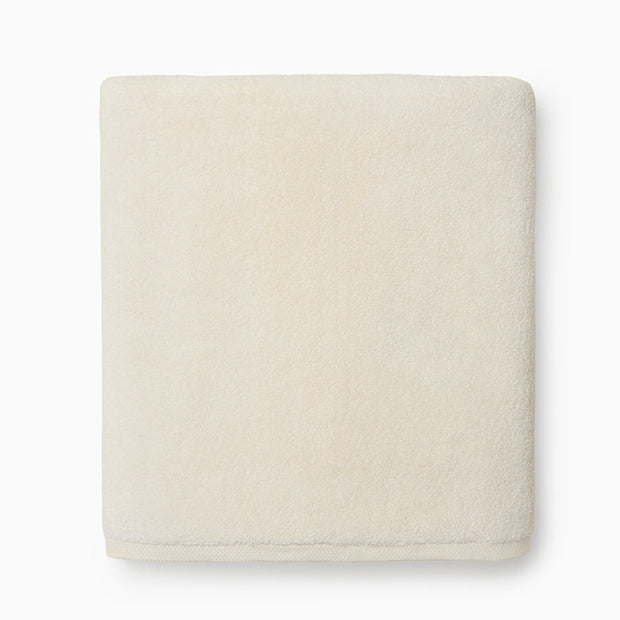 Ivory Sferra Cielo bath washcloth showing soft, plush fabric with subtle texture, perfect for gentle skincare and bath time.