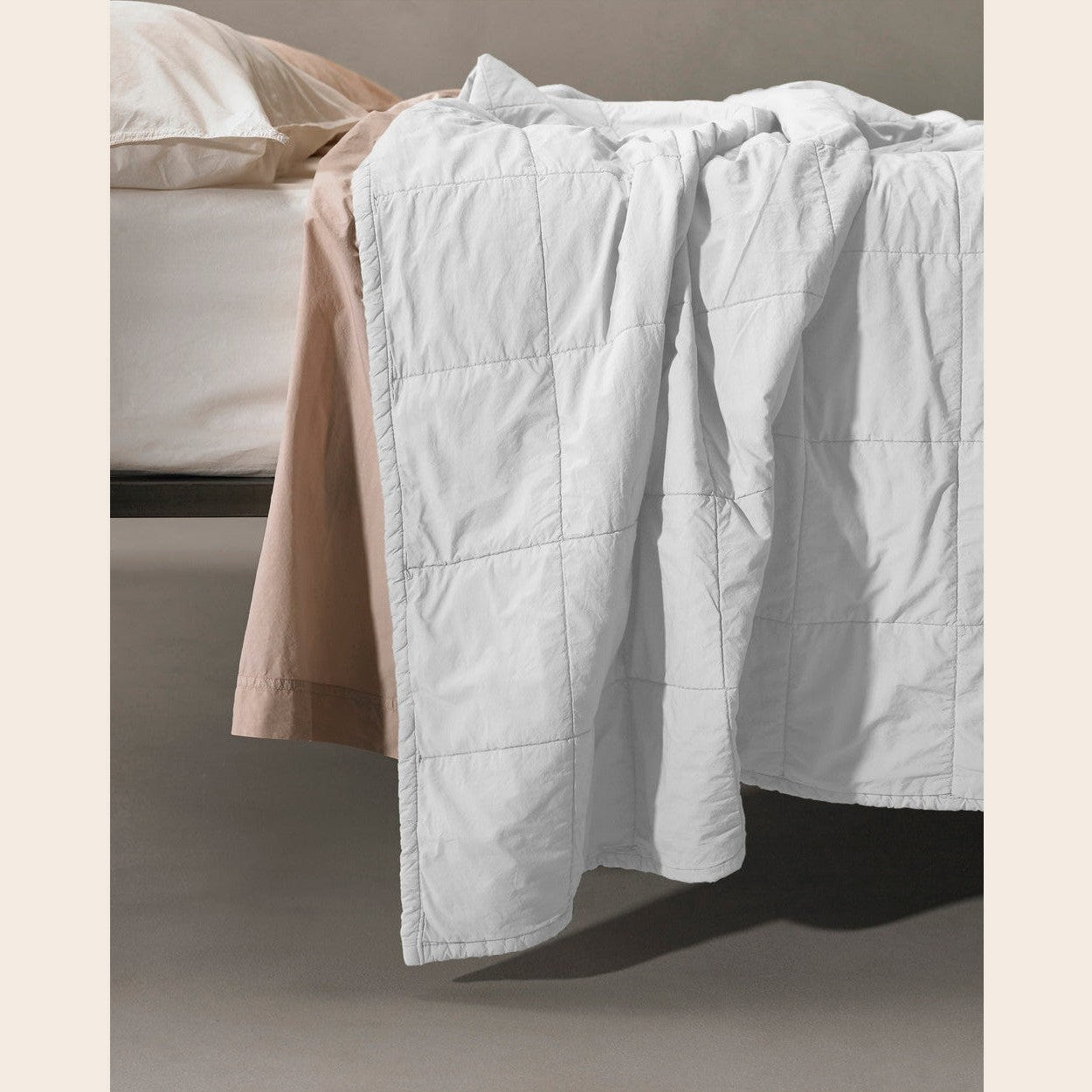Society Limonta Nite Quilt coverlet in white, showcasing its soft, textured fabric and elegant design for a cozy bedroom setting.