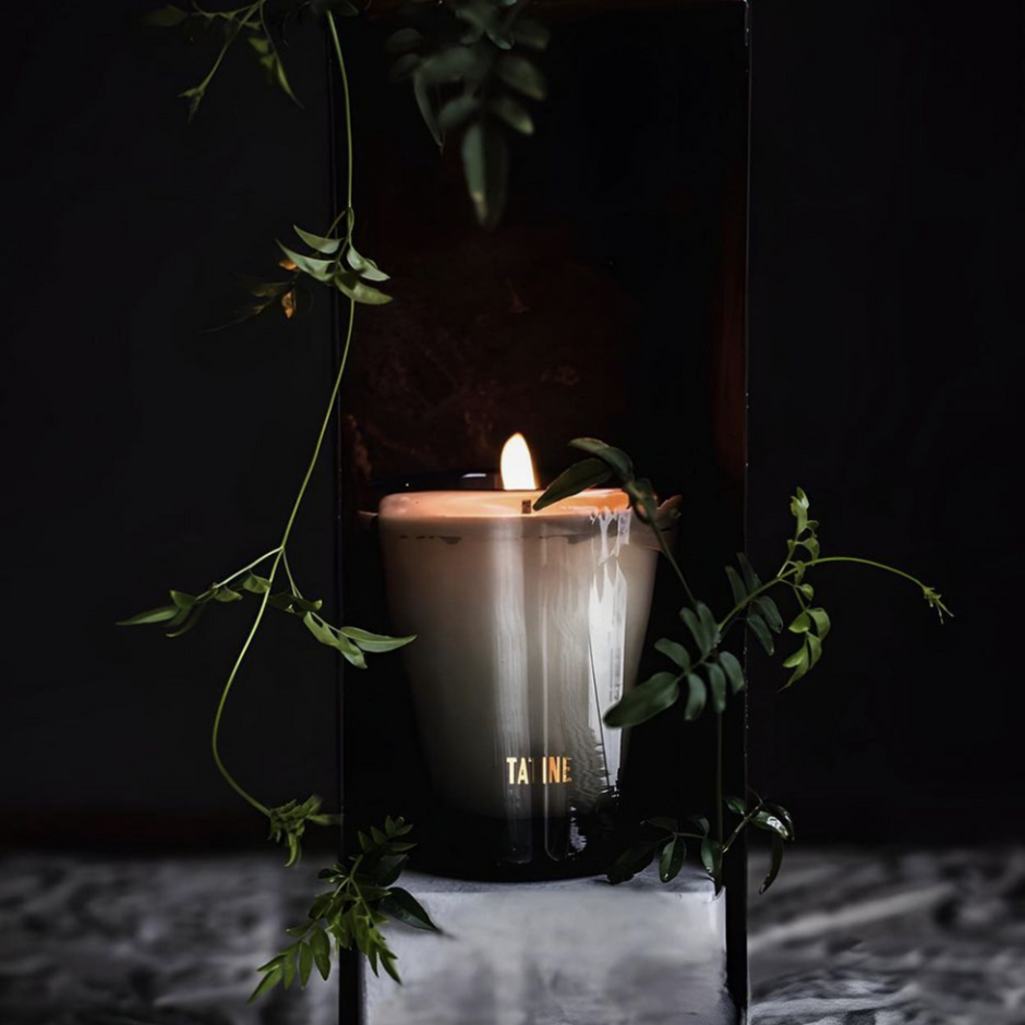 Tatine Stars Are Fire classic scented candle in a glass jar with a warm, inviting glow and decorative star design.