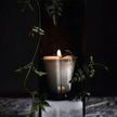 Tatine Stars Are Fire classic scented candle in a glass jar with a warm, inviting glow and decorative star design.