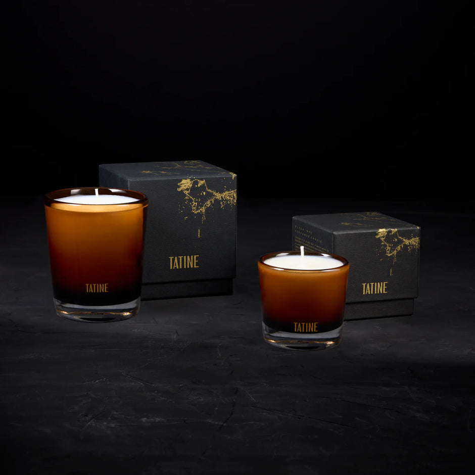 Tatine Stars Are Fire Classic Scented Candle with a warm, inviting glow and decorative star-shaped design in a glass jar.