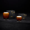 Tatine Stars Are Fire Classic Scented Candle with a warm, inviting glow and decorative star-shaped design in a glass jar.