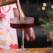 Ribbed vintage Art Deco coupe glass by The Wine Savant and Khen Glassware, featuring textured ribbed design and elegant shape.
