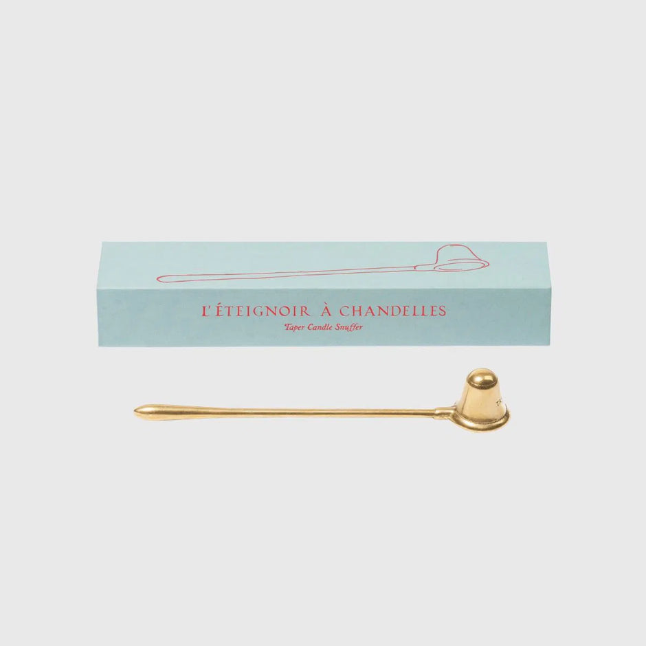 Trudon brass candle snuffer, a sleek candle accessory with a rounded handle, used for safely extinguishing candles.
