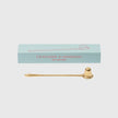 Trudon brass candle snuffer, a sleek candle accessory with a rounded handle, used for safely extinguishing candles.