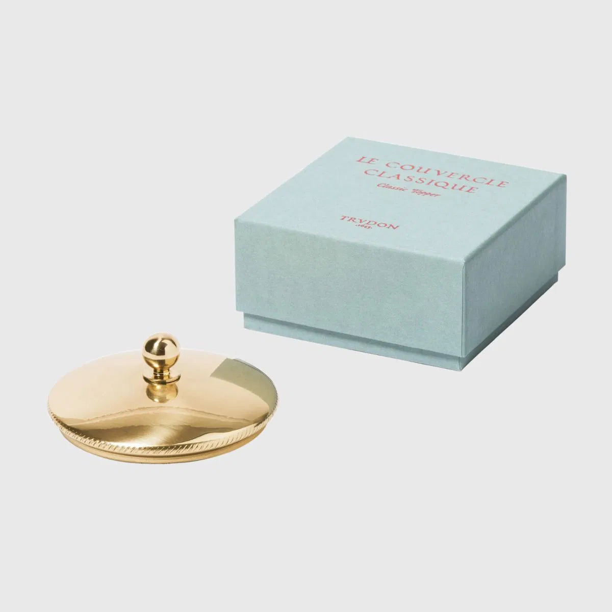 Trudon brass candle topper for candle accessories, featuring a sleek, polished brass design on a white background.